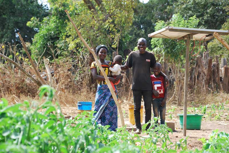 farmer and family with solar pump